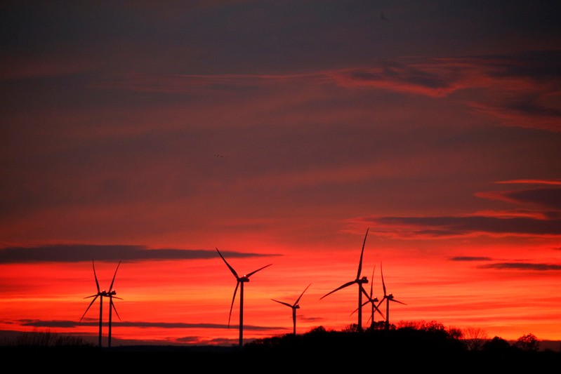 Power-generating windmill turbines are pictured at sunset at a wind park in Moeuvres near Cambrai
