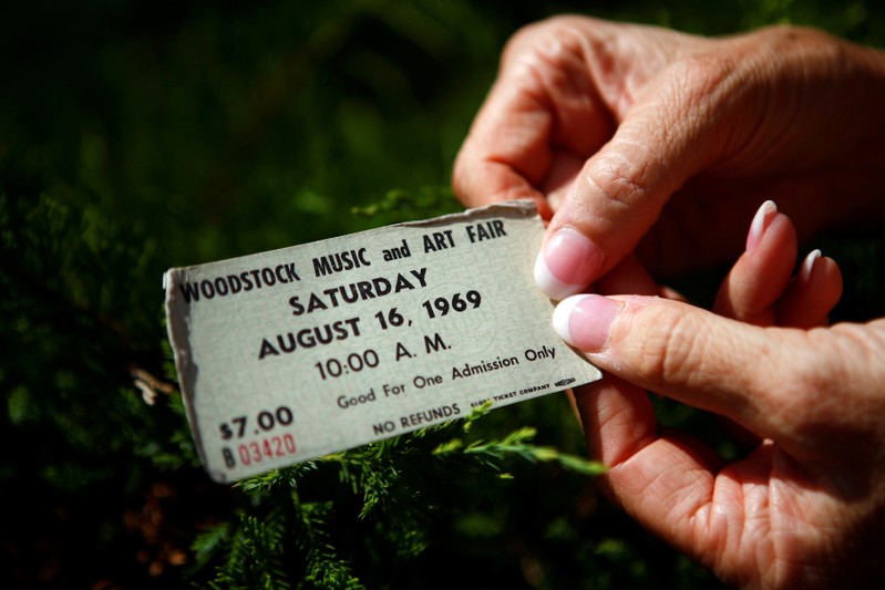 FILE PHOTO: A woman displays her original ticket at the site of the original Woodstock Music Festival in New York
