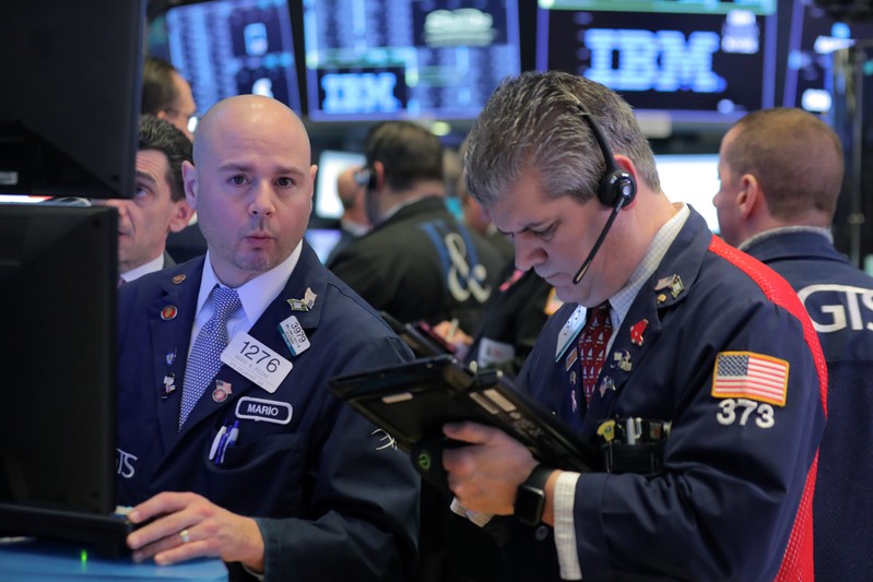 Traders work on the floor of the NYSE in New York