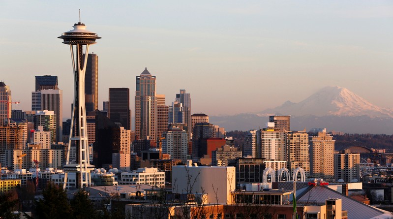 FILE PHOTO: The Space Needle and Mount Rainier are pictured at dusk in Seattle, Washington