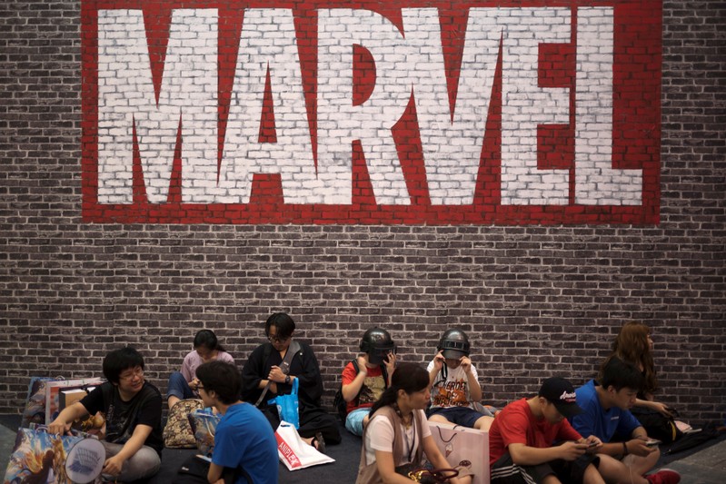 FILE PHOTO - Visitors sit under a Marvel sign at the China International Cartoon and Game (CCG) Expo in Shanghai