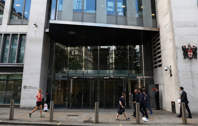 Pedestrians pass the London Stock Exchange in London