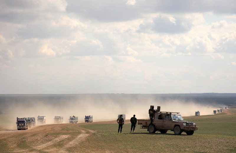 FILE PHOTO: Members of Syrian Democratic Forces (SDF) stand near a pick up truck near Baghouz