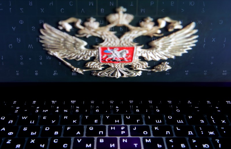 The coat of arms of Russia is reflected in a laptop screen in this picture illustration