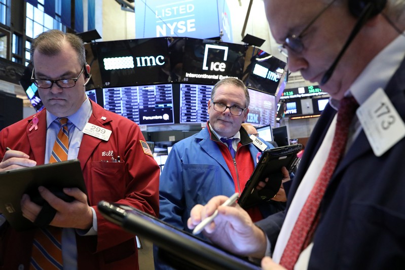 Traders work on the floor of the NYSE in New York