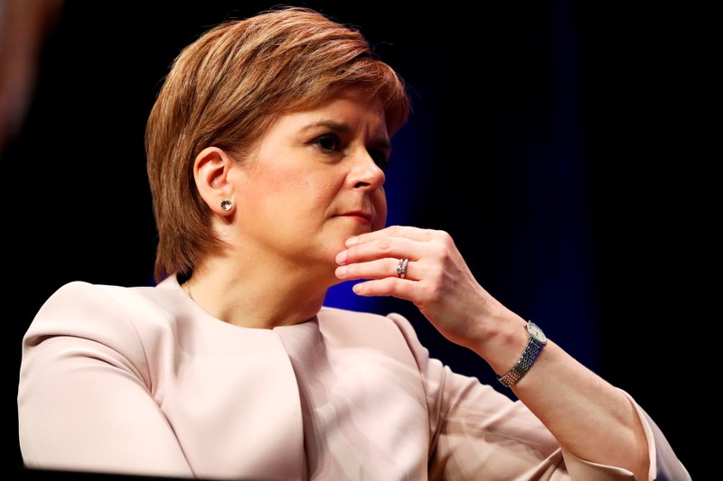 FILE PHOTO: Scotland's First Minister Nicola Sturgeon listens to Plaid Cymru's leader Adam Price speak at the Scottish National Party's party's conference in Glasgow, Scotland