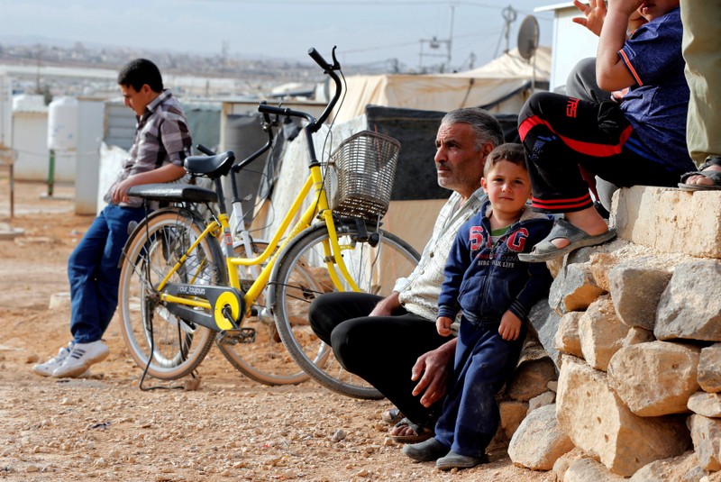FILE PHOTO: Syrian refugees sit and listen during a news conference by U.N. High Commissioner for Refugees Filippo Grandi at the Al Zaatari refugee camp in Jordan