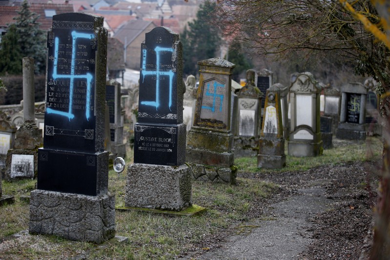 Graves desecrated with swastikas are seen in the Jewish cemetery in Quatzenheim