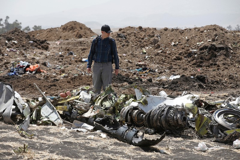 American civil aviation and Boeing investigators search through the debris at the scene of the Ethiopian Airlines Flight ET 302 plane crash, near the town of Bishoftu, southeast of Addis Ababa