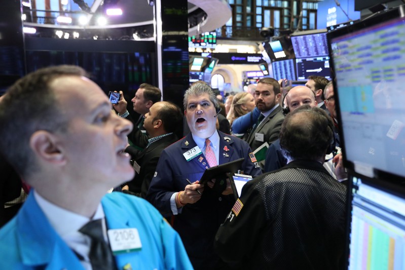 FILE PHOTO: Traders work on the floor of the NYSE in New York