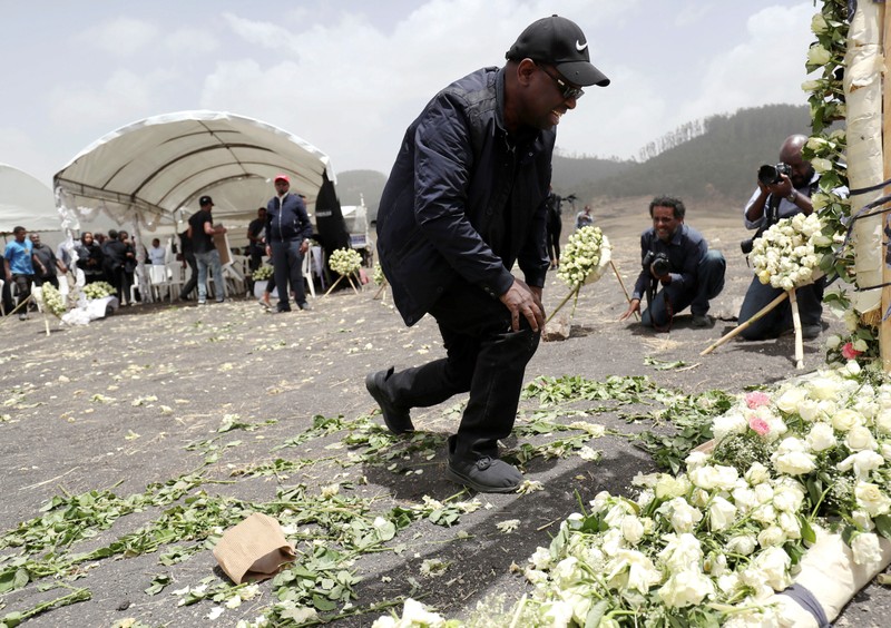 A relative mourns at the scene of the Ethiopian Airlines Flight ET 302 plane crash, near the town Bishoftu