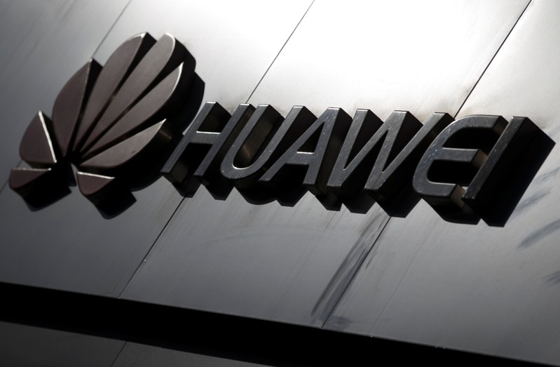 The Huawei brand logo is seen above a store of the telecoms equipment maker in Beijing