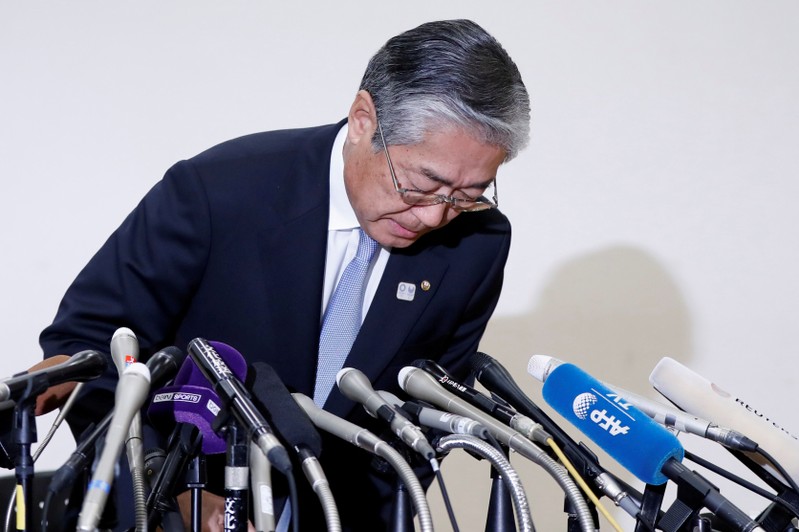 Tsunekazu Takeda, President of the Japanese Olympic committee, bows as he attends a news conference in Tokyo, Japan