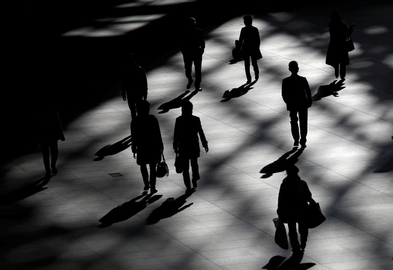 FILE PHOTO: People walk inside a building in Tokyo
