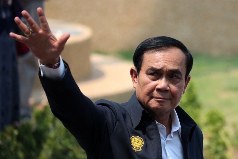 Thailand's Prime Minister Prayuth Chan-ocha gestures as he leaves Khon Kaen railway station after a visit ahead of the general election in Khon Kaen Province