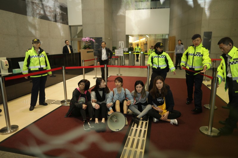 Protesters from Demosisto and Lingnan University surround by security after storming Hong Kong government headquarters over proposal to extradite fugitives to mainland China in Hong Kong