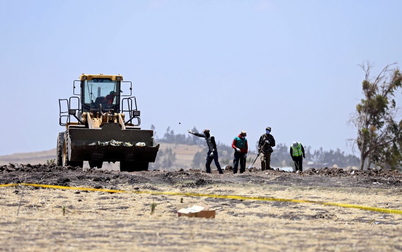 Villagers gather wreckages of the Ethiopian Airlines Flight ET 302 plane crash, near the town Bishoftu