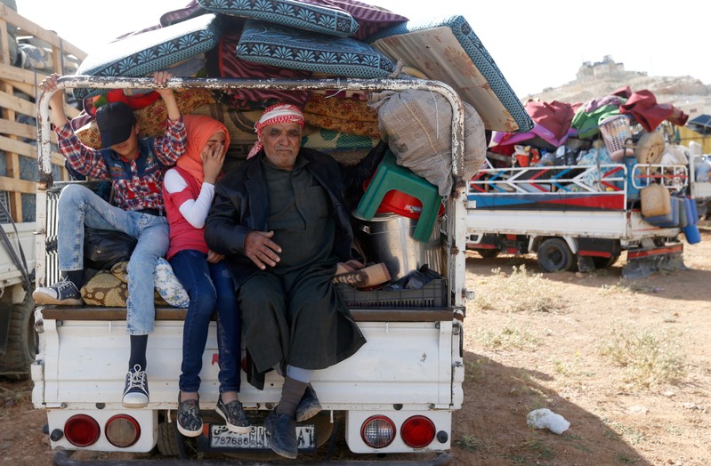 FILE PHOTO: Syrian refugees prepare to return to Syria from the Lebanese border town of Arsal