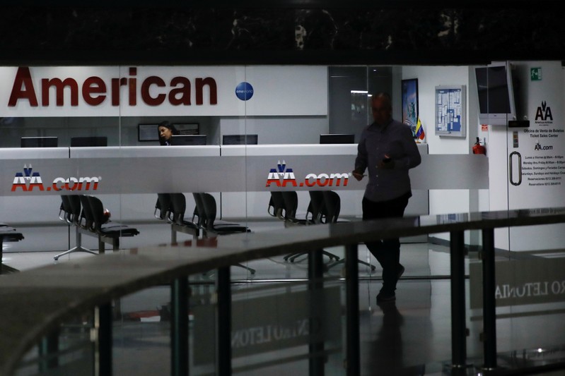 A man walks past the American Airlines office in Caracas