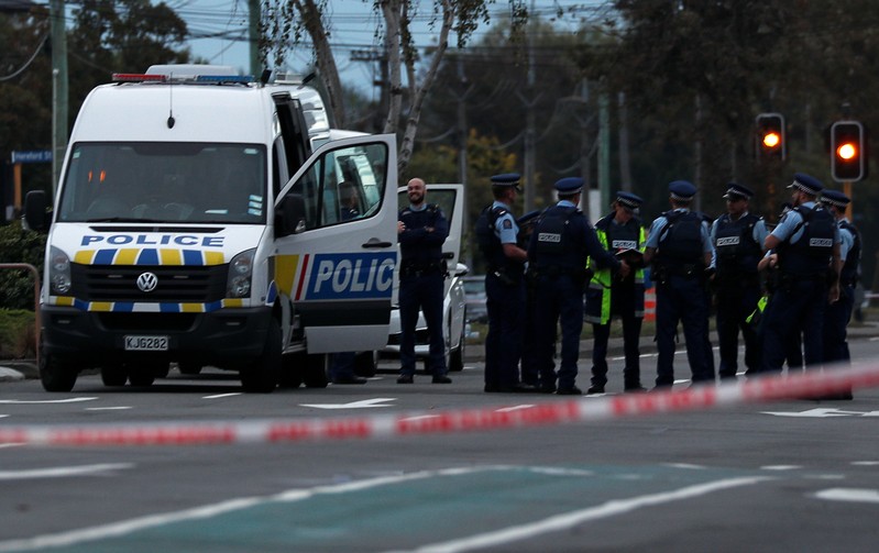 Police officers gather outside Linwood mosque after Friday's attacks, in Christchurch