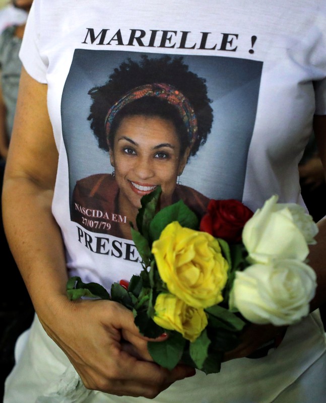 A woman attends a mass marking the first anniversary of activist and councilwoman Marielle Franco's murder, in Rio de Janeiro
