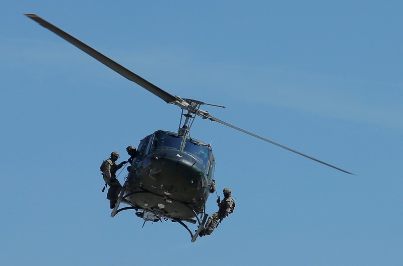 FILE PHOTO: Members of Austrian special operations unit Jagdkommando perform an exercise on an Agusta Bell 212 helicopter in Wiener Neustadt