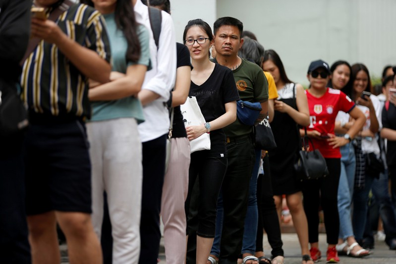 People like up for their early vote for the upcoming Thai election at a polling station in Bangkok