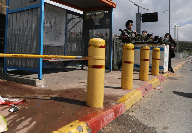 Israeli soldiers stand guard near the scene of Palestinian shooting attack near the Jewish settlement of Ariel, in the occupied West Bank