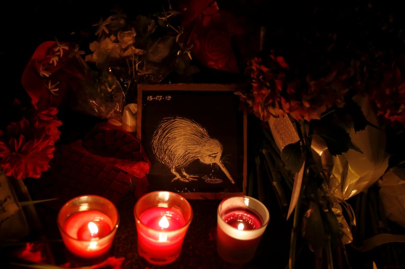 Candles are flowers placed at a memorial site for victims of the mosque shootings are pictured at the Botanic Gardens in Christchurch