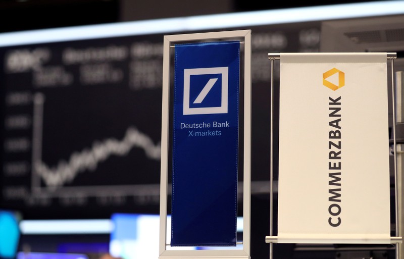 FILE PHOTO: FILE PHOTO: Banners of Deutsche Bank and Commerzbank are pictured in front of the German share price index, DAX in Frankfurt