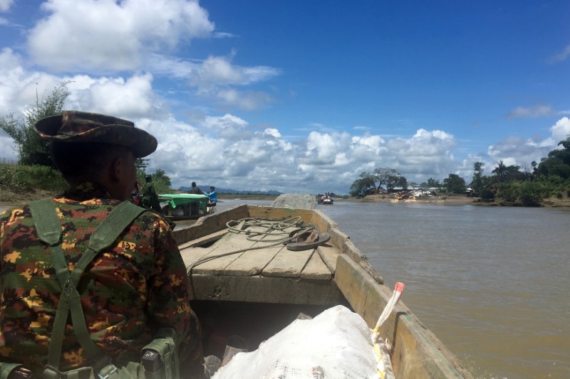 A Myanmar soldier patrols in a boat at the Mayu river near Buthidaung in the north of Rakhine state, Myanmar