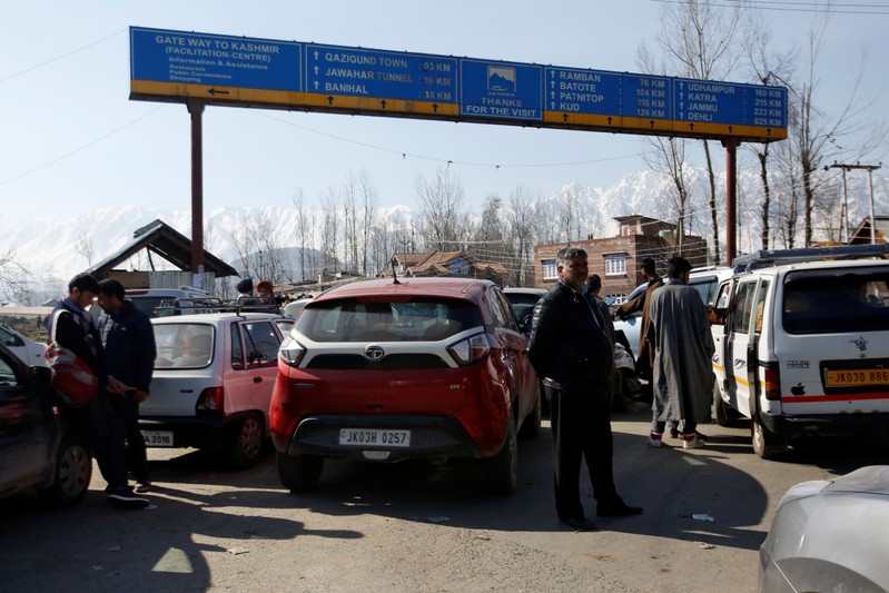 Traffic is stopped as the Indian Central Reserve Police Force (CRPF) convoy moves along a national highway in Qazigund