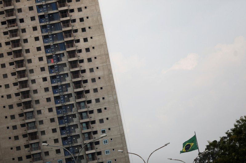 Brazilian flag is seen next to a residential building under construction in Sao Paulo