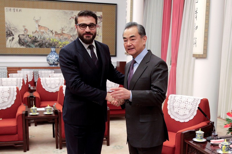 FILE PHOTO: Afghanistan National Security Advisor Hamdullah Mohib shakes hands with Chinese Foreign Minister Wang Yi before their meeting in Beijing