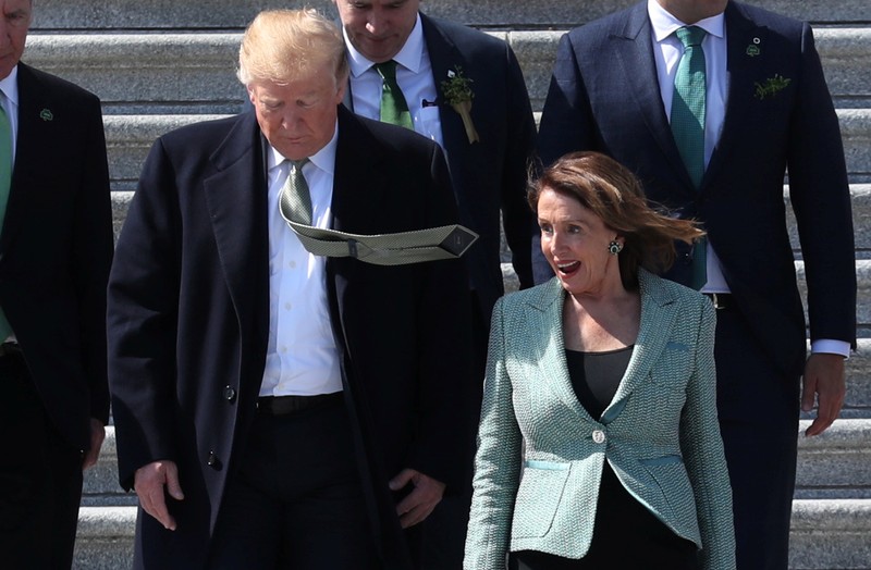 U.S. President Trump walks down Capitol steps with Speaker of the House Pelosi after they attended luncheon at U.S. Capitol in Washington