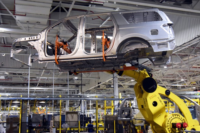 FILE PHOTO: A large robot nicknamed ÒKongÓ lifts the body of a Ford Expedition SUV at FordÕs Kentucky Truck Plant in Louisville