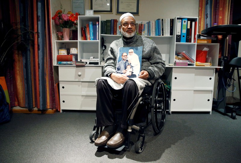 Al Noor mosque shooting survivor Farhid Ahmed poses with a photo of his wife Husna, who was killed in the attack, after an interview with Reuters in Christchurch, New Zealand