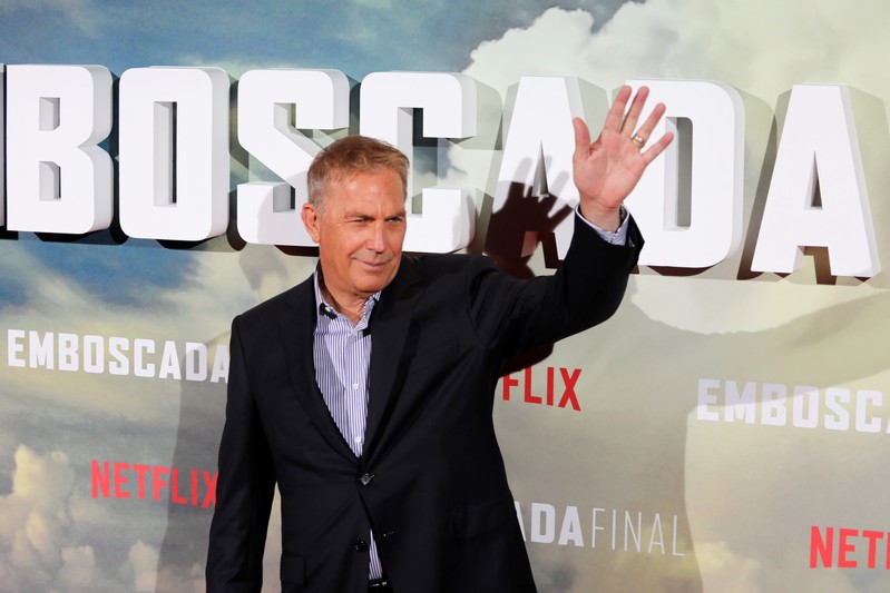 Actor Costner waves during a photocall to promote his latest film