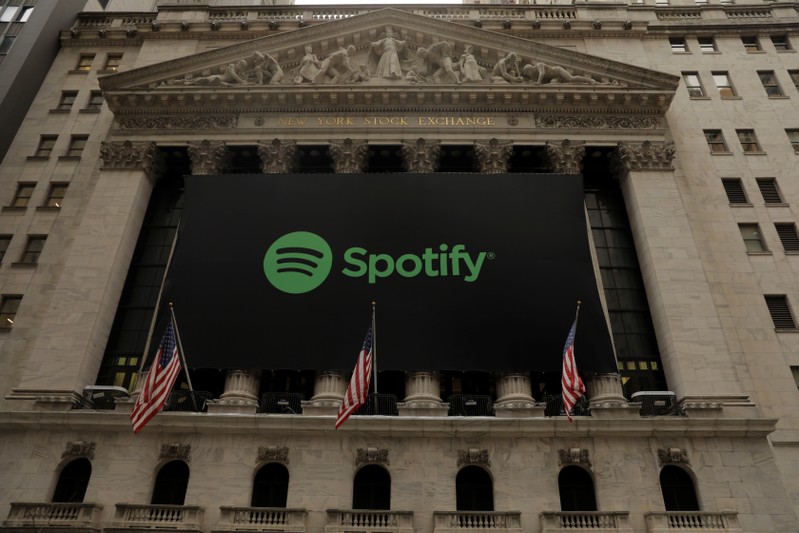 The Spotify logo hangs on the facade of the New York Stock Exchange as the company lists its stock with a direct listing in New York