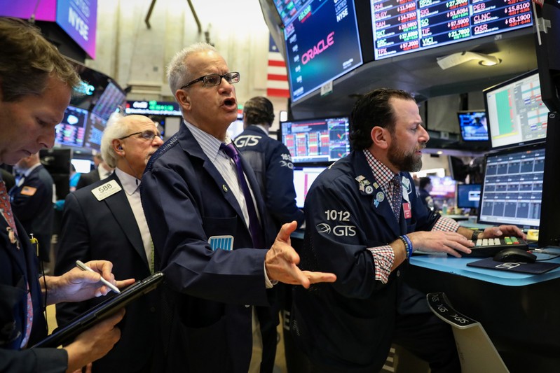 Traders work on the floor at the NYSE in New York