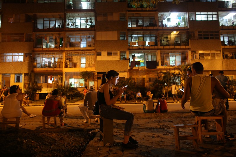 FILE PHOTO: Aguilar uses a mobile phone to connect to the internet at a hotspot in downtown Havana