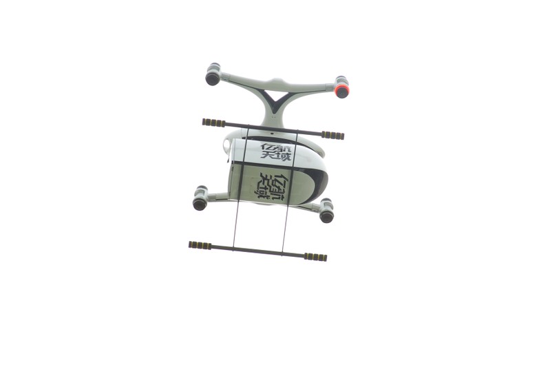 Autonomous aerial vehicle company EHang delivers coffee with its Falcon drone to the delegation on a government-organised tour to the Guangdong-Hong Kong-Macao Greater Bay Area, in Guangzhou