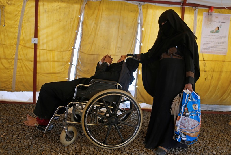 Woman sits in a wheelchair as she waits for medical care at a cholera treatment center in Sanaa