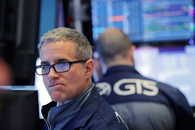 A trader works on the floor of the New York Stock Exchange shortly after the opening bell in New York