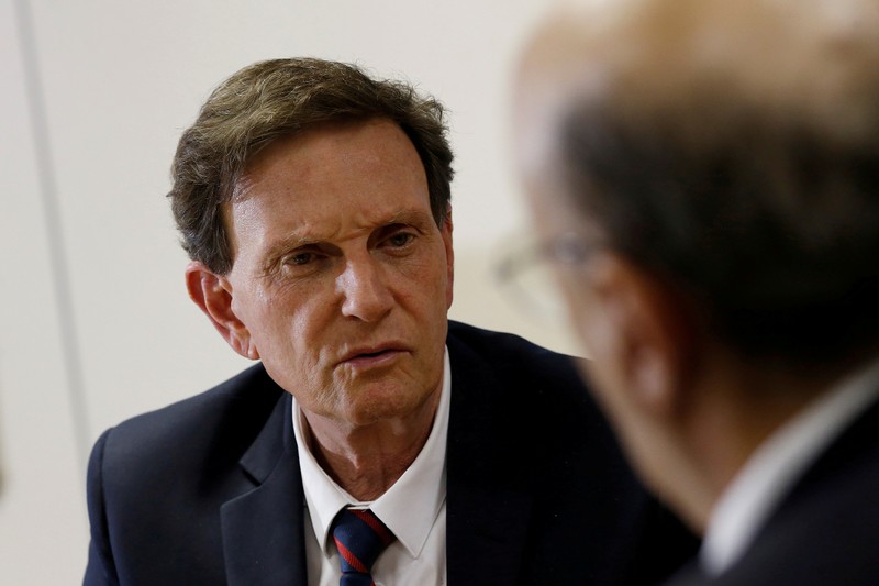 FILE PHOTO: Rio de Janeiro's Mayor Crivella speaks with Brazil's Finance Minister Meirelles during a meeting in Brasilia
