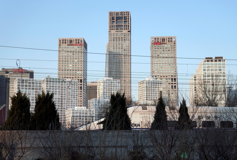 FILE PHOTO: A CRH bullet train runs past Beijing's central business area