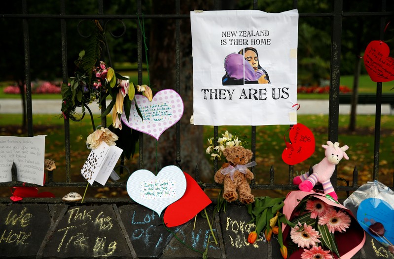Flowers and signs are seen at a memorial site for victims of the mosque shootings, at the Botanic Gardens in Christchurch