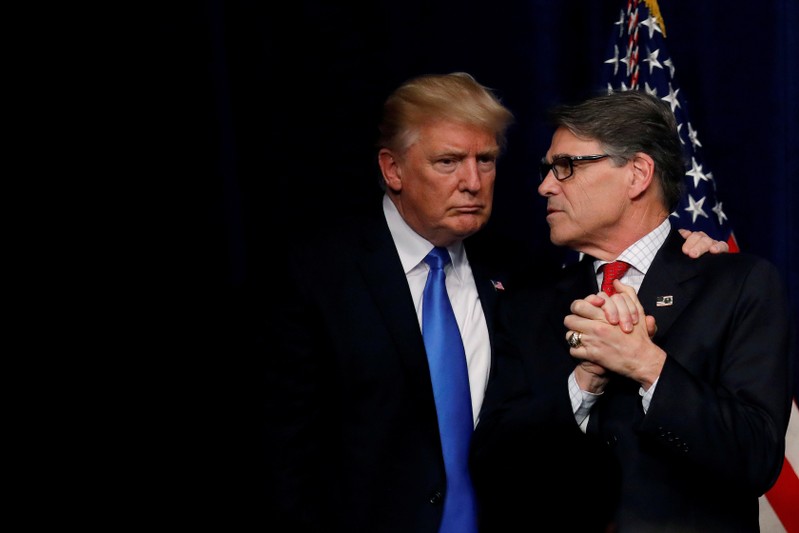 FILE PHOTO: U.S. President Donald Trump talks with Energy Secretary Rick Perry after delivering remarks during an