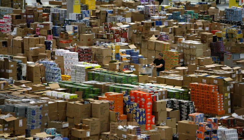 FILE PHOTO: A worker sorts packages at the Amazon warehouse in Leipzig