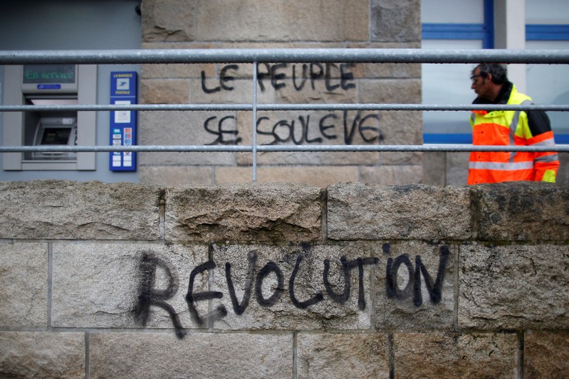 A man looks at the slogan which reads